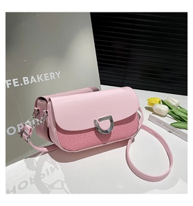 Detail view of pink crossbody bag showing fabric textures and silver D-ring metal buckle