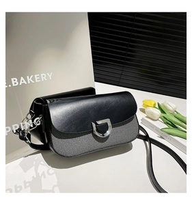 Detail of grey fabric and black leather contrast shoulder bag with silver D-buckle closure