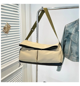 Detail of canvas travel bag with olive adjustable strap and dual front pockets