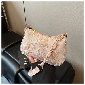 Detail of pink lace shoulder bag with 3D butterfly embroidery and resin chain handle