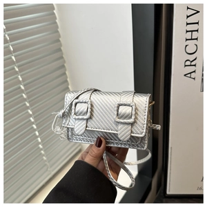 Detail of silver mini crossbody bag with metal texture and double buckle decorative closure