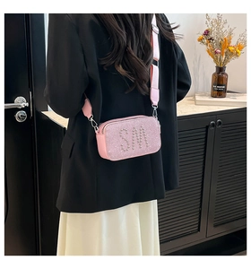 Detail of pink camera bag with sparkling SM rhinestone letters and wide shoulder strap