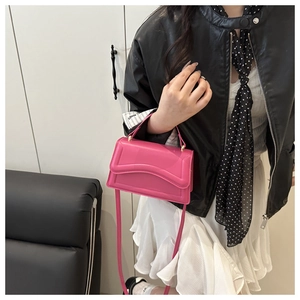 Fashionable pink leather handbag shown on a model with a stylish black leather outfit