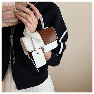 Detail of a brown and white patchwork crossbody bag with Fashion & Bags brand tag