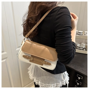Detailed view of women's vintage contrast crossbody bag with twin decorative buckles