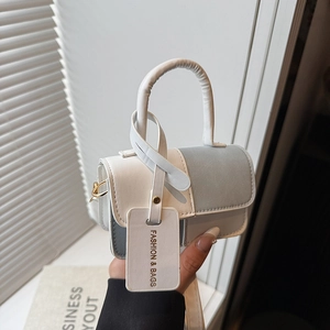 Fashionable white and light blue leather crossbody handbag with handle and tag