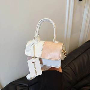 Fashionable white and champagne pink patchwork handbag with top handle and crossbody strap
