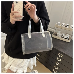 Detail view of the silver metallic handle and semi-transparent mesh handbag texture