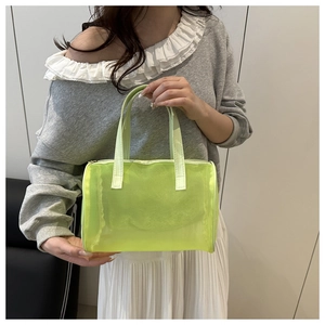 Detail view of neon green mesh toiletry bag with double handles and metal zipper closure