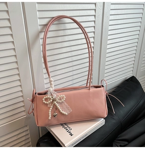 Detailed view of pink sweet style shoulder bag with pearl bow and lace decorations