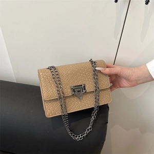 Stone textured beige crossbody bag with metallic chain strap and industrial buckle
