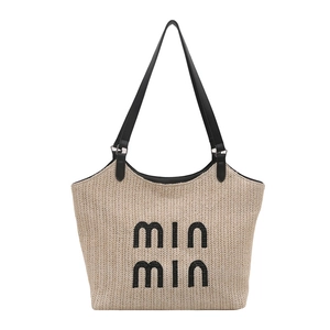 Straw woven tote bag with contrast black shoulder straps and min min embroidery