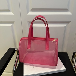 High-capacity pink mesh travel cosmetic bag with leather handles and gold zipper