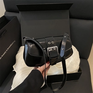 Glossy black patent leather crossbody bag with silver buckle and matching gift box
