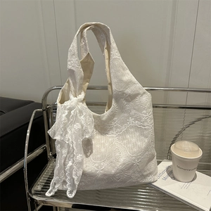 Elegant white lace tote bag with floral embroidery and large decorative bow strap