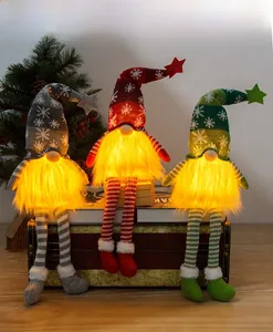 Three Christmas long-legged gnomes with warm LED glowing beards on vintage books