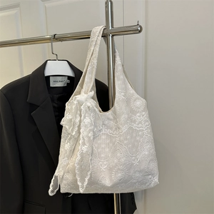 Elegant white lace tote bag with floral embroidery and large bow detail hanging