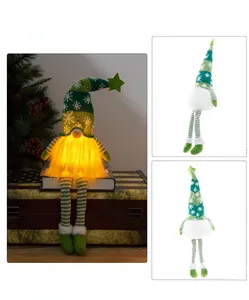 Detail of Christmas gnome plush with LED warm light and long green striped legs