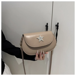 Detail view of khaki half-round saddle bag with rhinestone star and thin strap
