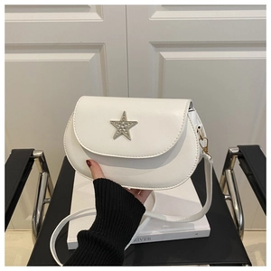 Detail of white saddle bag with silver rhinestone star buckle and PU leather texture