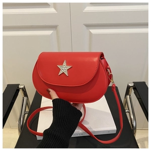 Detail of red saddle bag featuring a large sparkling silver rhinestone star buckle