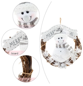 Detailed macro view of plush snowman and wooden Merry Christmas sign on rattan wreath