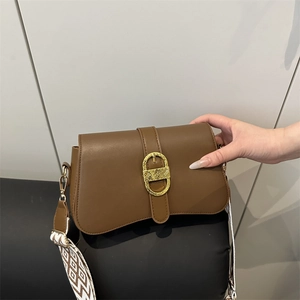 Brown leather crossbody bag with vintage gold buckle and woven geometric shoulder strap