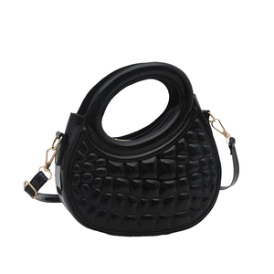 Glossy black crescent handbag with embossed brick pattern and gold-tone hardware