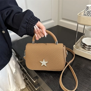 Brown star-studded chain handbag with pearl-inlay star for women in home setting