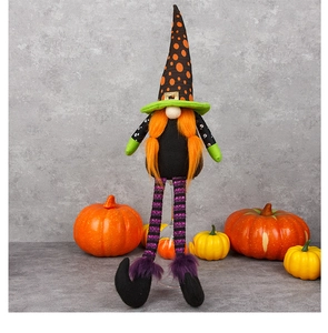 Détail d'un gnome d'Halloween aux longues jambes rayées et chapeau de sorcière à pois