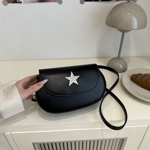 Minimalist black saddle bag with a sparkling star lock buckle for summer 2025 fashion