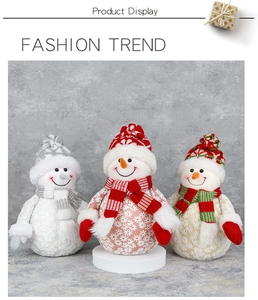 Three plush Christmas snowmen with knit hats and scarves on a professional studio display