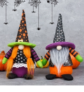 Close-up of two Halloween gnome plush dolls with pointy hats and festive orange pumpkins