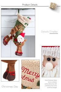 Close-up of Merry Christmas embroidery on green Christmas stocking with plush 3D reindeer
