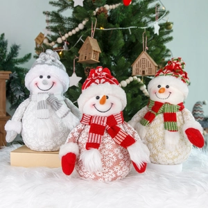 Three plush Christmas snowman figurines in silver, red, and gold festive holiday outfits