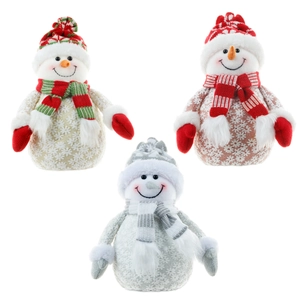 Three plush Christmas snowman figurines in festive knit outfits for holiday window display