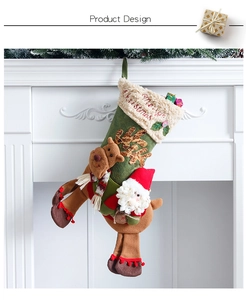 Detail of green Christmas stocking with 3D Santa and reindeer on white fireplace