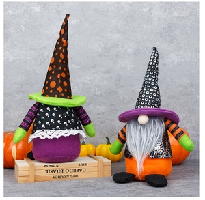 Detail of two Halloween gnomes with pointy hats and long beards on a rustic wooden crate