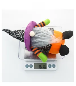 Detail shot showing the 167g weight of a Halloween plush gnome on a digital scale
