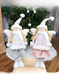 Detail of Christmas angel dolls with retractable legs and white feather wings