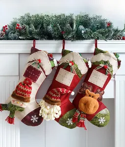 Detailed view of 3D Santa, Snowman and Reindeer large Christmas stockings hanging on fireplace