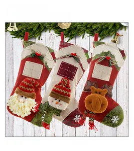 Detailed view of three festive Christmas stockings with Santa, snowman and elk characters