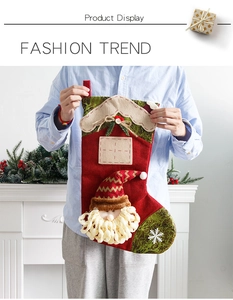 Detail of large Santa Claus Christmas stocking gift bag with green pattern and soft 3D decor