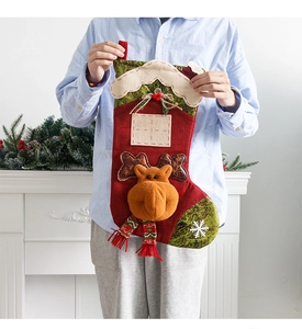 Close-up of a large red Christmas stocking with 3D reindeer decor and snowflake patterns