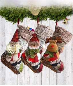 Three Christmas stockings with 3D Santa, Snowman and Reindeer on faux wood grain fabric
