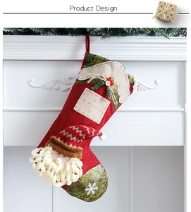 Close-up of a red 3D Santa Christmas stocking hanging on a white fireplace mantle