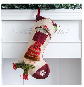 Detail of 3D snowman Christmas stocking with snowflake embroidery on fireplace