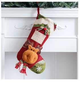 Detail of Christmas stocking with 3D plush reindeer and name tag hanging on a fireplace