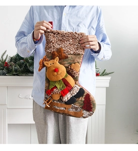 Detail of Christmas stocking featuring a 3D skiing reindeer with rustic burlap texture