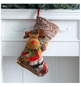 Detail of Christmas stocking featuring a 3D plush reindeer on an ivory and brown fabric